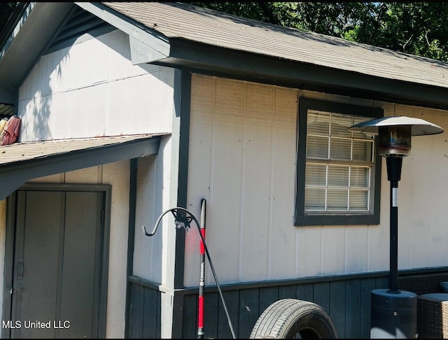 view of side of home with central AC unit