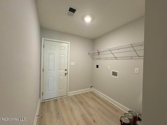 laundry room with electric dryer hookup, light hardwood / wood-style flooring, and washer hookup