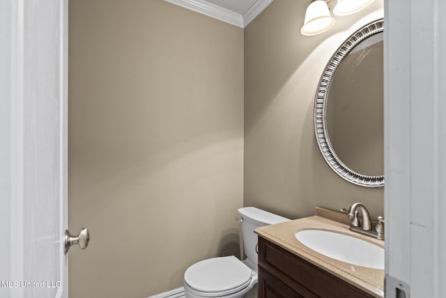 half bath featuring vanity, crown molding, and toilet
