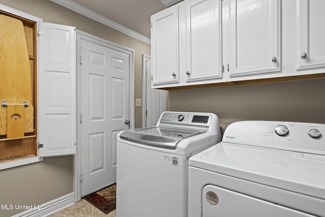 laundry area with baseboards, cabinet space, ornamental molding, and washing machine and clothes dryer