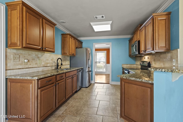 kitchen featuring stone countertops, visible vents, appliances with stainless steel finishes, and brown cabinetry