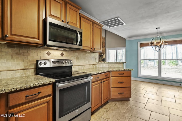 kitchen with light stone countertops, visible vents, stainless steel appliances, a notable chandelier, and brown cabinets