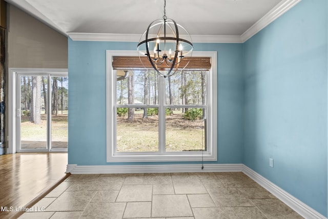 unfurnished dining area featuring a notable chandelier, crown molding, and baseboards