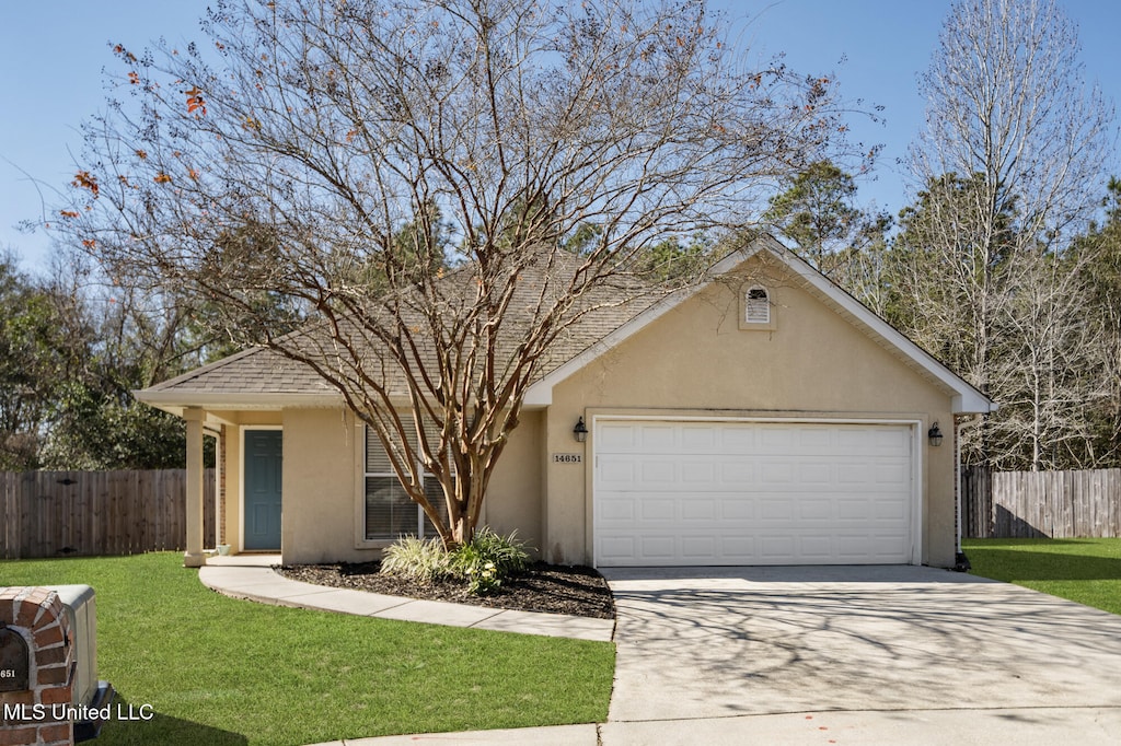 view of front of home with a garage and a front yard