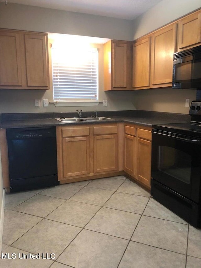 kitchen with black appliances, sink, and light tile patterned floors