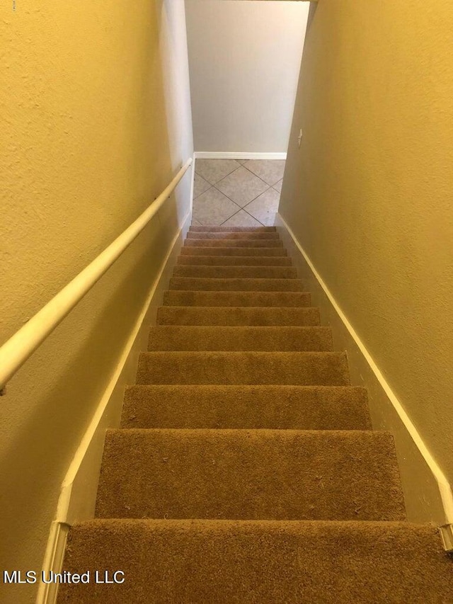 stairs with tile patterned floors