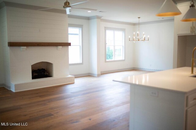 256 Arbor Trl, Brandon, MS 39047 - unfurnished living room with light wood-style floors, a chandelier, baseboards, ceiling fan, and a large fireplace