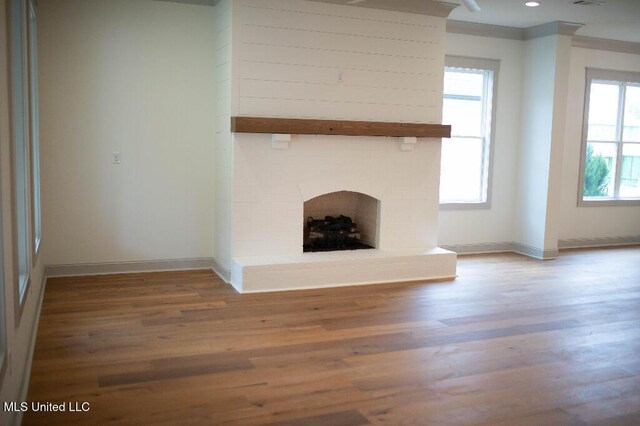 256 Arbor Trl, Brandon, MS 39047 - unfurnished living room with wood finished floors, baseboards, and a fireplace