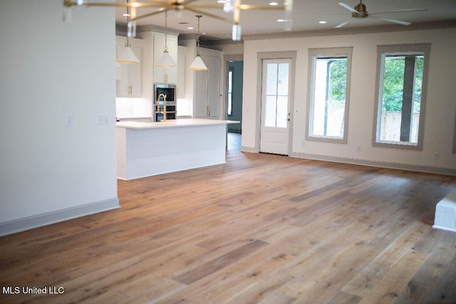 256 Arbor Trl, Brandon, MS 39047 - kitchen featuring double oven, ceiling fan, baseboards, white cabinetry, and light wood finished floors
