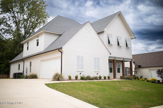 256 Arbor Trl, Brandon, MS 39047 - view of front facade with a front yard, concrete driveway, central air condition unit, an attached garage, and roof with shingles