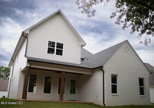256 Arbor Trl, Brandon, MS 39047 - rear view of house with ceiling fan, a shingled roof, brick siding, and a yard