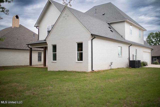 256 Arbor Trl, Brandon, MS 39047 - back of house with a yard, brick siding, central AC unit, and roof with shingles