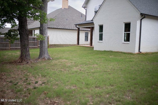 256 Arbor Trl, Brandon, MS 39047 - back of house featuring a chimney, brick siding, and roof with shingles