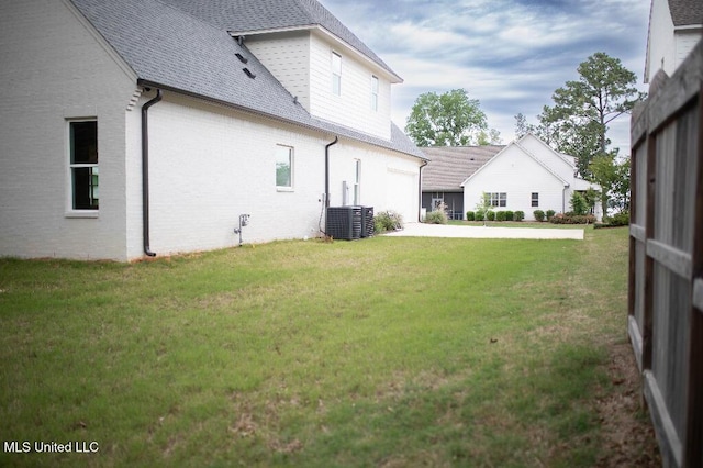 256 Arbor Trl, Brandon, MS 39047 - view of grassy yard featuring driveway, central AC, and a garage