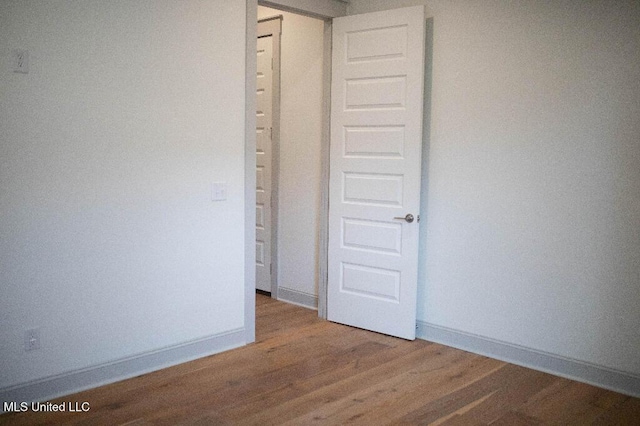 256 Arbor Trl, Brandon, MS 39047 - unfurnished bedroom with wood finished floors and baseboards