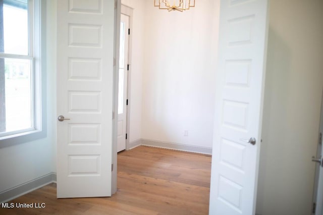 256 Arbor Trl, Brandon, MS 39047 - spare room featuring a chandelier, light wood-style flooring, and baseboards
