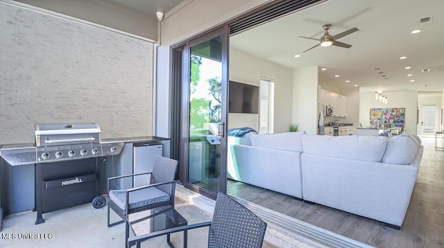 living room with wood-type flooring and ceiling fan