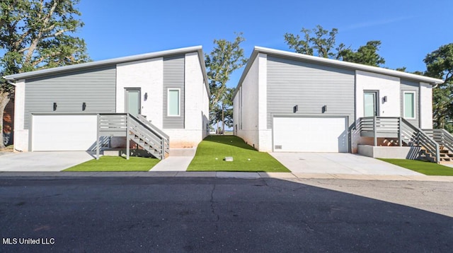 bi-level home featuring a front yard and a garage