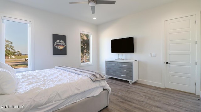 bedroom with hardwood / wood-style flooring and ceiling fan