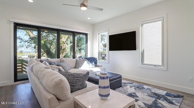 living room featuring hardwood / wood-style floors and ceiling fan