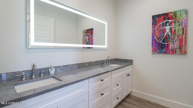 bathroom with hardwood / wood-style floors and vanity