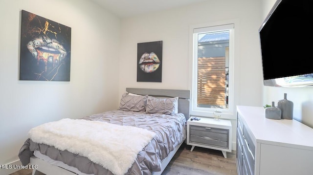 bedroom with dark hardwood / wood-style flooring