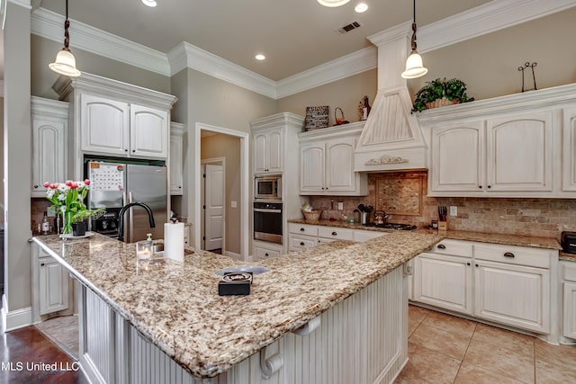 kitchen featuring decorative backsplash, light stone countertops, stainless steel appliances, and visible vents