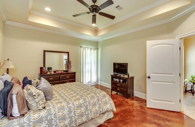 bedroom with visible vents, ornamental molding, ceiling fan, and a tray ceiling