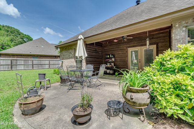 view of patio / terrace with ceiling fan, fence, french doors, and outdoor dining space