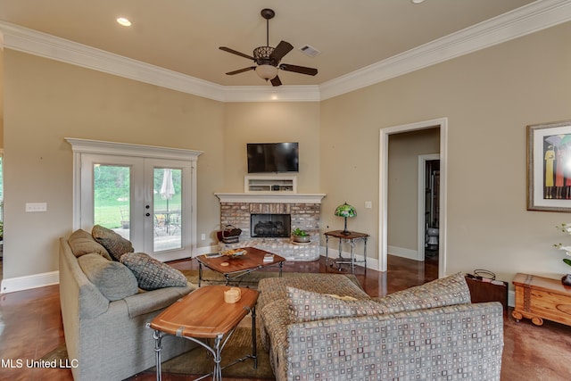 living area featuring ornamental molding, a fireplace, baseboards, ceiling fan, and french doors