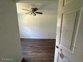 unfurnished room featuring ceiling fan and dark hardwood / wood-style flooring