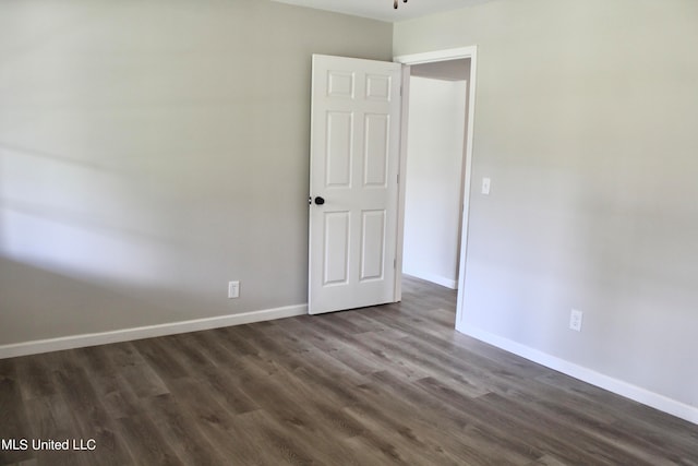 empty room featuring dark hardwood / wood-style flooring