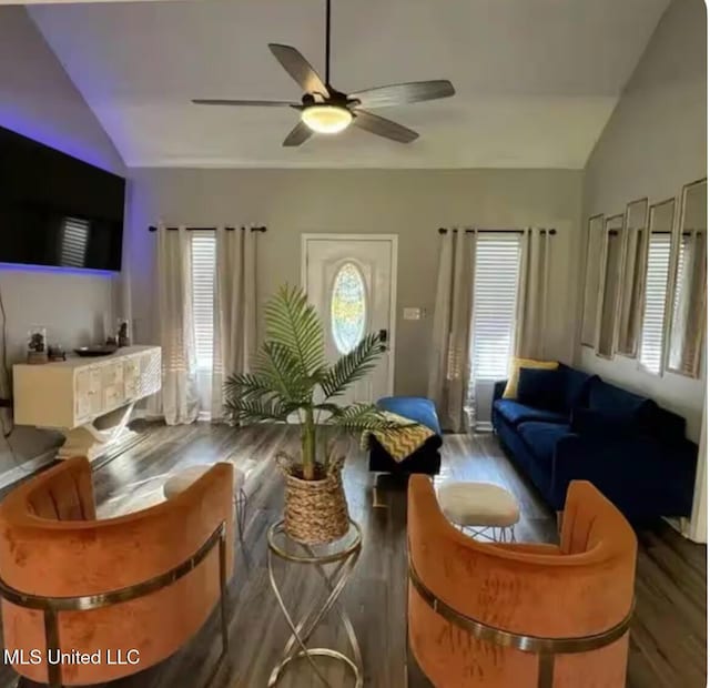 living room featuring lofted ceiling, ceiling fan, and wood finished floors