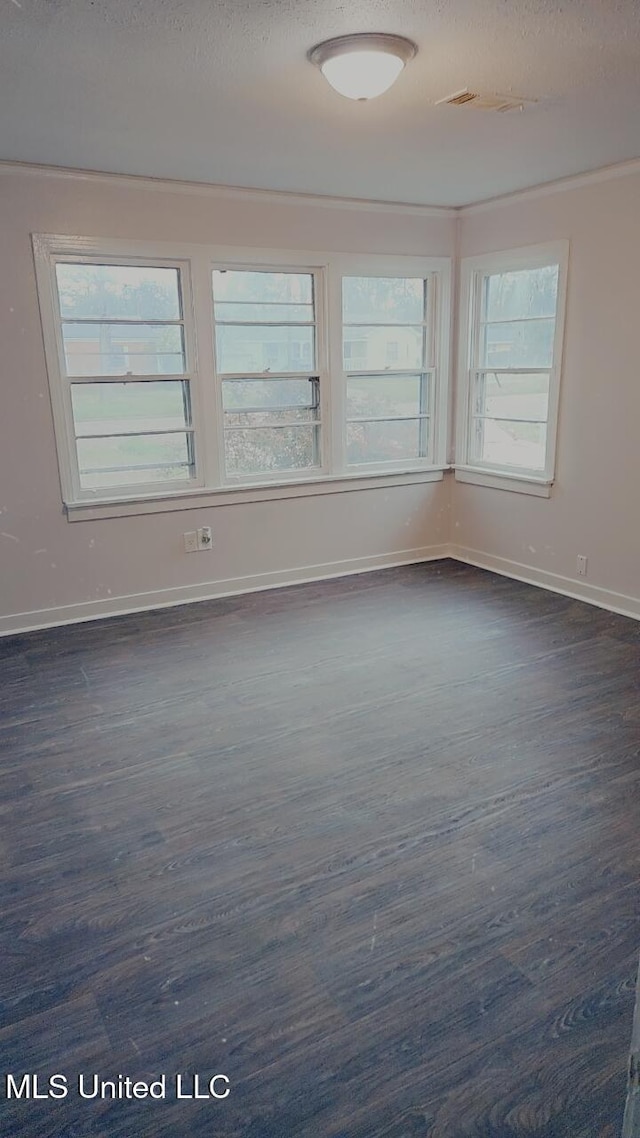 unfurnished room with dark hardwood / wood-style floors and a textured ceiling