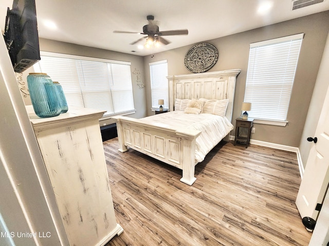 bedroom featuring light hardwood / wood-style floors and ceiling fan