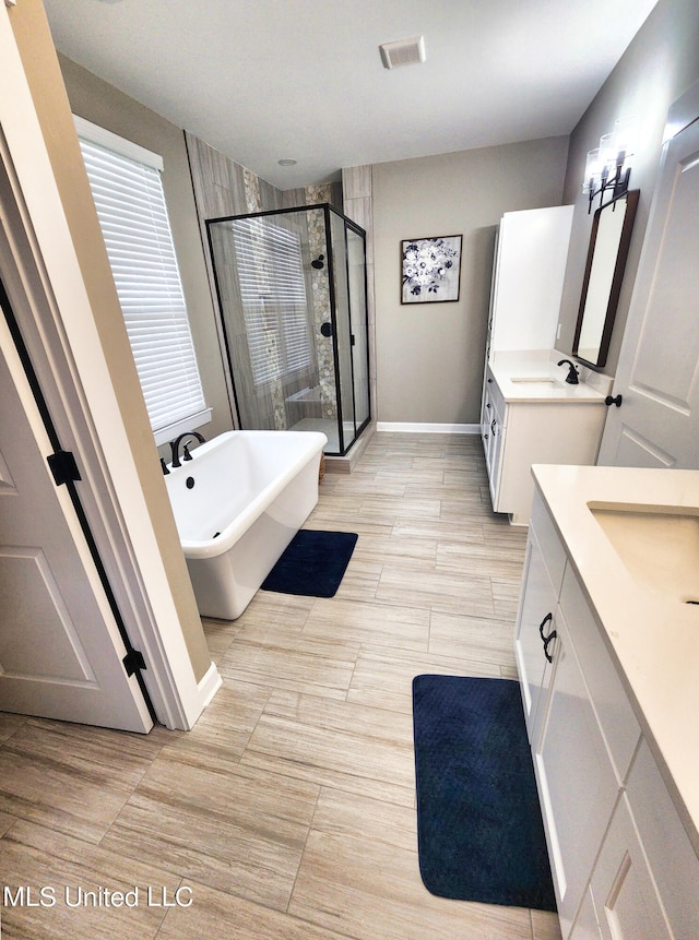 bathroom featuring vanity and separate shower and tub