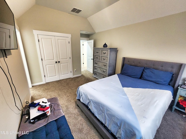 carpeted bedroom featuring a closet and vaulted ceiling