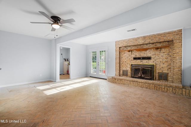 unfurnished living room with visible vents, a brick fireplace, baseboards, a ceiling fan, and water heater