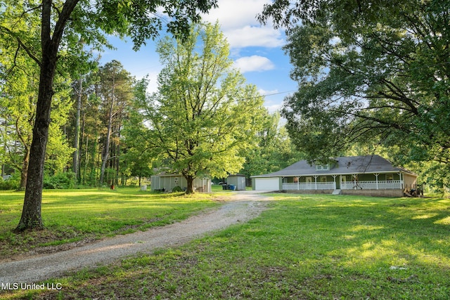 country-style home with covered porch, driveway, and a front lawn