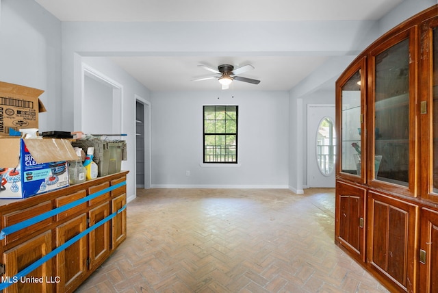 interior space featuring a ceiling fan and baseboards