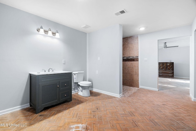 full bathroom featuring a ceiling fan, visible vents, baseboards, toilet, and tiled shower