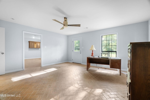 unfurnished office featuring baseboards, ceiling fan, and visible vents