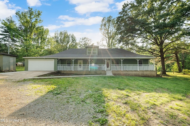 country-style home featuring a porch, an attached garage, concrete driveway, and a front lawn