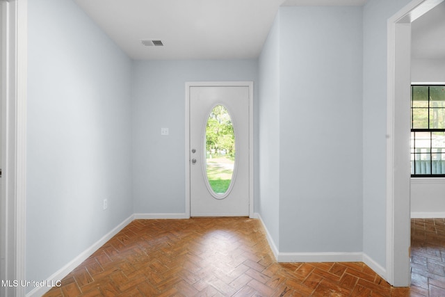 entrance foyer featuring baseboards and visible vents