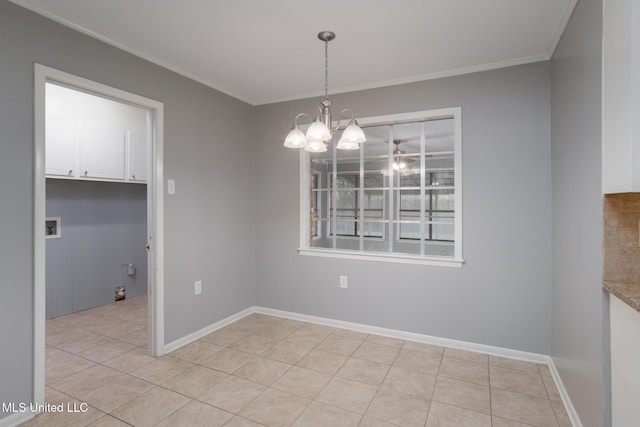 unfurnished dining area featuring a chandelier, light tile patterned floors, baseboards, and crown molding