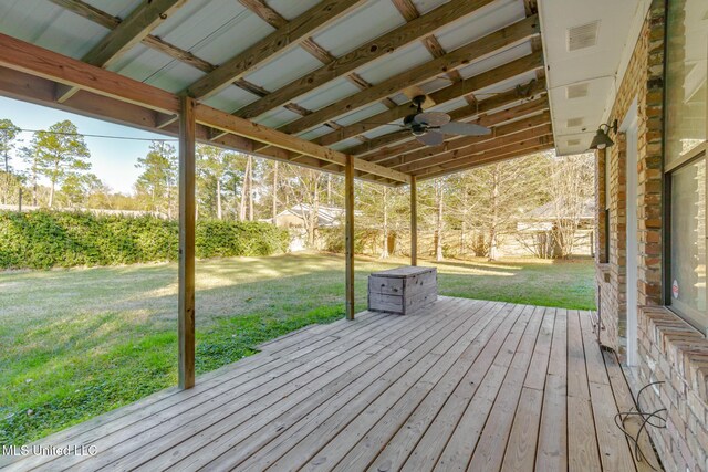 deck with visible vents and a yard