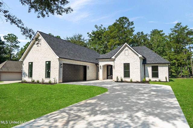 french country inspired facade with a front lawn and a garage