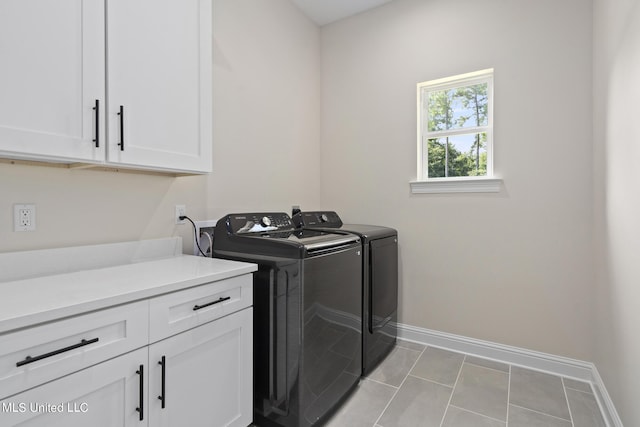 washroom featuring cabinets, independent washer and dryer, and light tile patterned flooring