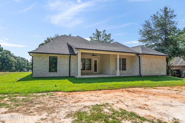 back of house with a yard, a patio area, and ceiling fan