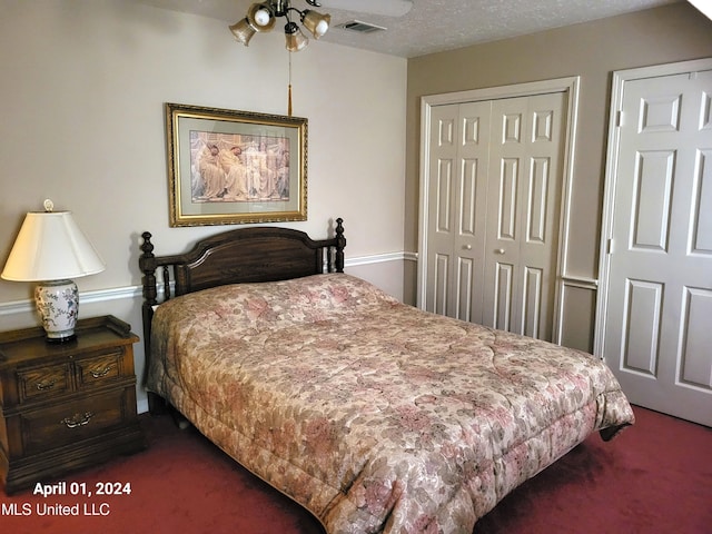 carpeted bedroom with a textured ceiling and ceiling fan